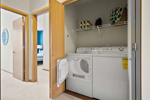 a washer and dryer in a laundry room with a closet