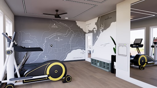 A room with a wall map of the United States and two stationary exercise bikes.