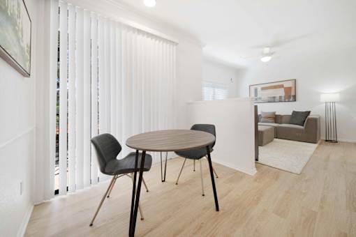 A dining room with a table and chairs.