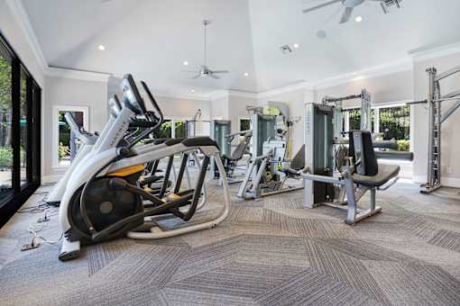 A spacious home gym with a variety of equipment.