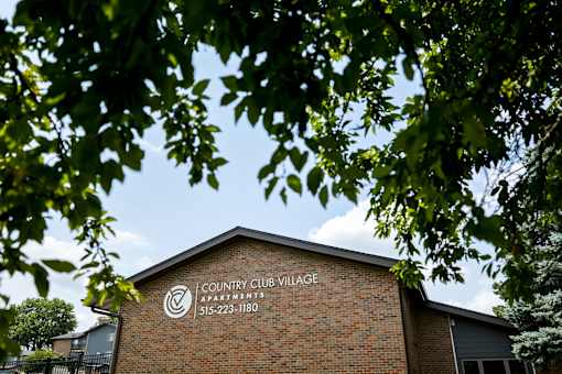 A building with a sign that says Country Club Village.