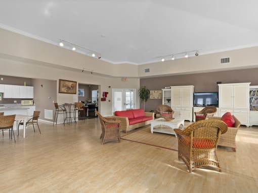 a large living room with furniture and a kitchen at The Groves at Wimauma Apartments , Wimauma, 33598