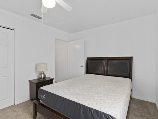 a bedroom with a bed and a closet at The Groves at Wimauma Apartments , Florida 33598