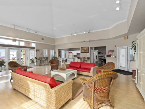 a living room with couches and chairs and a table at The Groves at Wimauma Apartments , Wimauma
