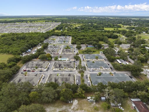 an aerial view of an empty parking lot in a city at The Groves at Wimauma Apartments , Wimauma, FL
