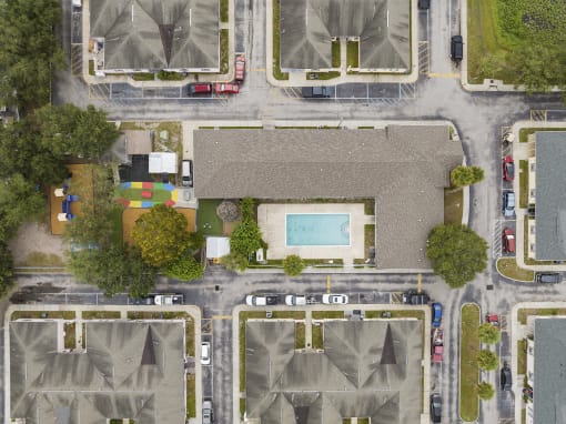 a birds eye view of a neighborhood with houses and a pool at The Groves at Wimauma Apartments , Wimauma, 33598