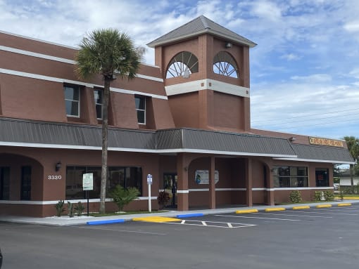 a building with a clock tower on top of it at Colonial Apartments, Orlando, 32808
