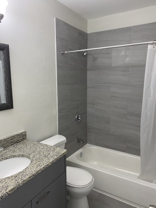 a bathroom with a sink toilet and bathtub at Colonial Apartments, Florida