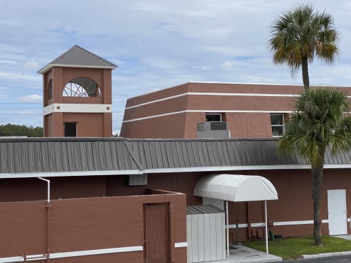 a picture of a building with a clock tower in the background at Colonial Apartments, Orlando