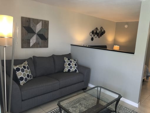 a living room with a couch and a coffee table at Colonial Apartments, Orlando, FL 32808