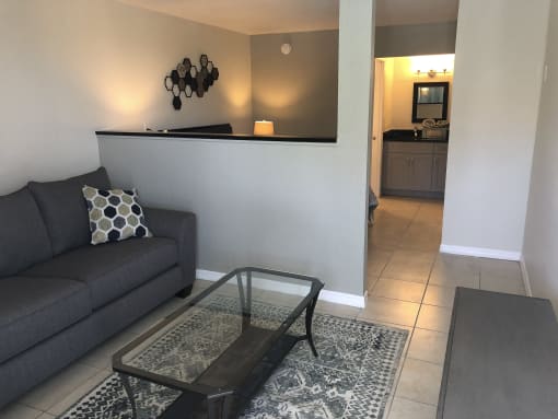 a living room with a couch and a coffee table at Colonial Apartments, Florida, 32808