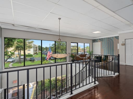 a lobby with a view of a yard and a table and chairs  at Cypress Grove, Lauderhill, 33313
