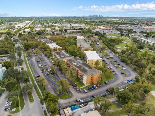 an aerial view of an empty parking lot with buildings and trees at Cypress Grove, Lauderhill, FL, 33313