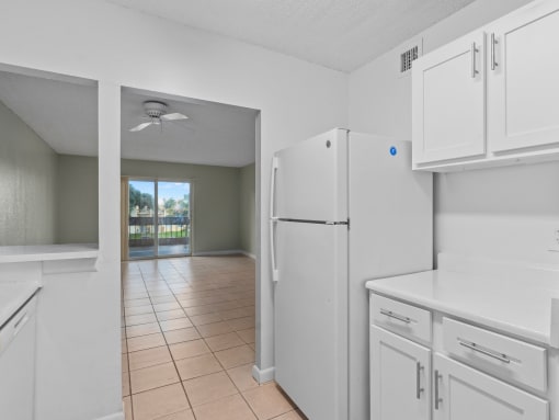 a kitchen with white cabinets and a white refrigerator at Cypress Grove, Lauderhill, 33313