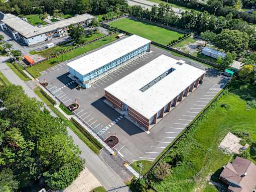 A large building with a parking lot in front of it.