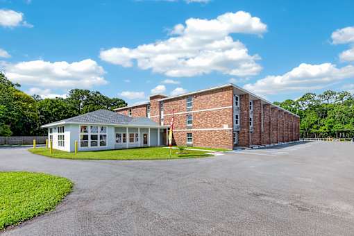 A large building with a parking lot in front of it.