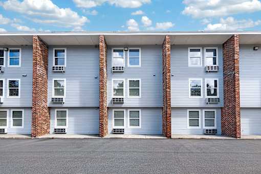 A row of apartment buildings with garage doors.