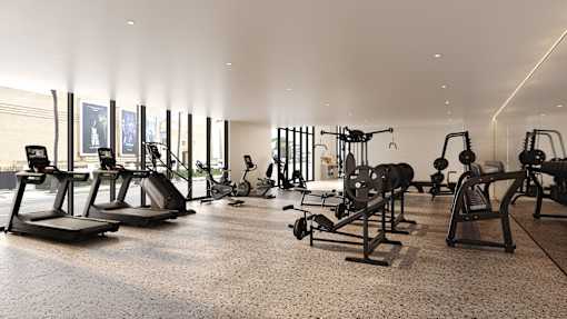 A gym with a variety of equipment including treadmills, weights, and exercise machines.at WM by CLG, California  