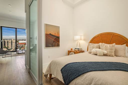 A bedroom with a large bed and a painting of a road with power lines on the wall at WM by CLG, California  