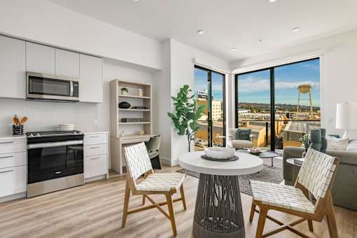 A modern kitchen with a dining table and chairs at WM by CLG, Los Angeles California  