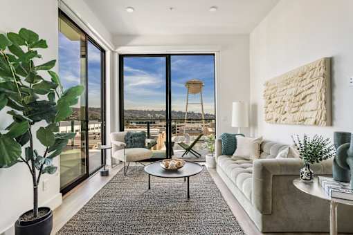 A living room with a large window overlooking a landscape at WM by CLG, Los Angeles  