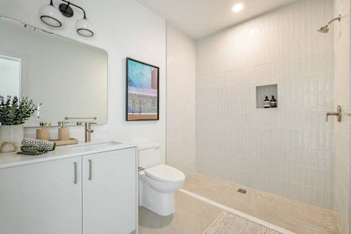A bathroom with a white toilet and a white sink at WM by CLG, Los Angeles, 90232  