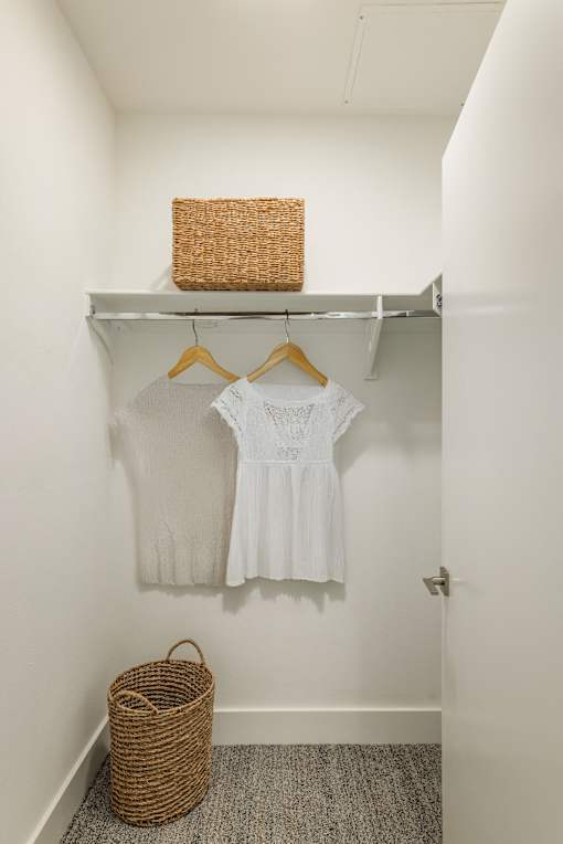 A white shirt is hanging on a white shelf at WM by CLG, Los Angeles  