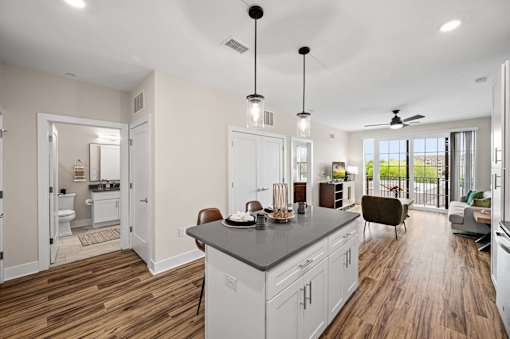 A kitchen with a large island and a dining area.