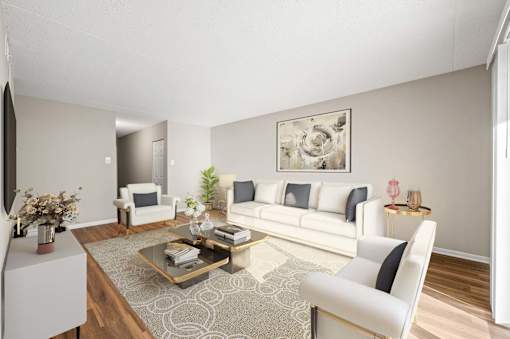A living room with a white sofa, a coffee table, and a painting on the wall.