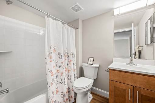 A white toilet sits next to a white sink in a bathroom.