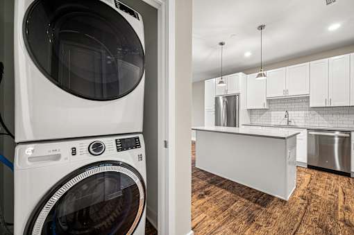 A white washing machine in a laundry room.