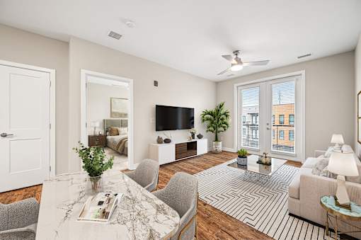 A living room with a white ceiling and a large window.