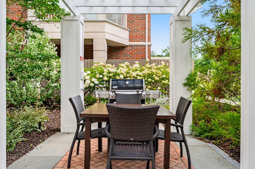 A patio with a table and chairs and a laptop on it.