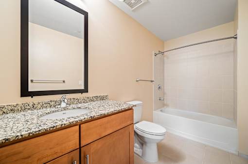 A bathroom with a sink, toilet, and bathtub.