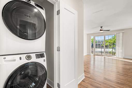 A white washing machine and dryer in a laundry room.
