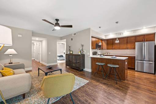 A modern kitchen with a wooden island and stainless steel appliances.