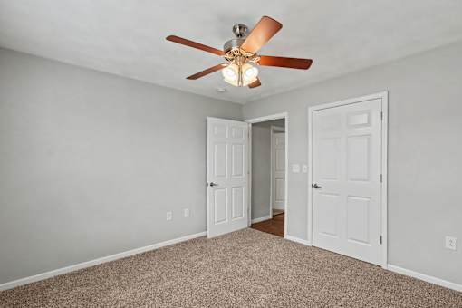 Northbrooke Commons bedroom with ceiling fan and plush carpeting