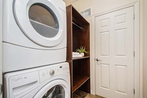 A white washing machine and dryer in a small laundry room.