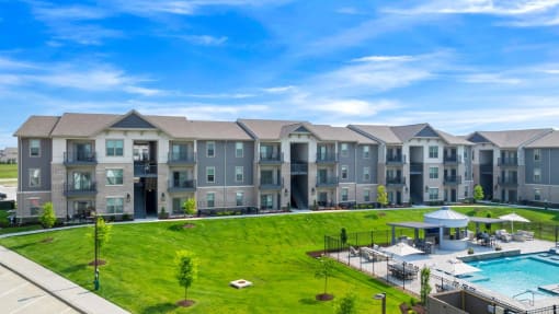 an aerial view of an apartment building with a swimming pool at The Prairie Luxury Apartments, Dardenne Prairie, 63368