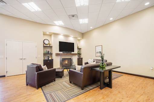 A living room with a fireplace and a television.