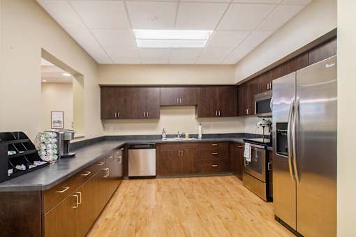 Kitchen with cherry oak cabinets and light wooden floors.
