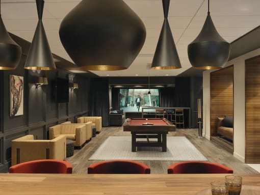 Clubroom with pool table, conversational seating and multiple televisions  at Clayton On The Park, Missouri, 63105