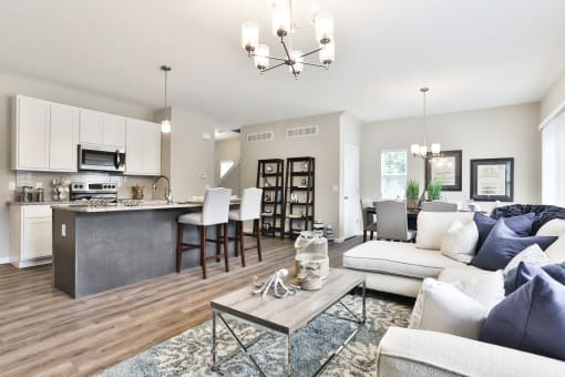 a living room and kitchen with a couch and a table