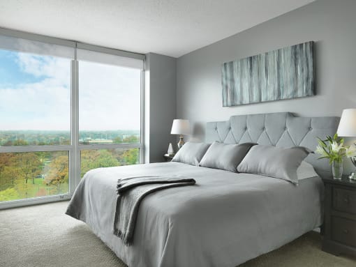 Apartment bedroom with large bed and floor-to-ceiling windows  at Clayton On The Park, Clayton, 63105