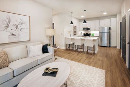 a living room and kitchen with a couch and a table at The Prairie Luxury Apartments, Dardenne Prairie