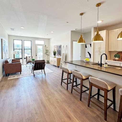 A kitchen with a bar area and a view of the city.