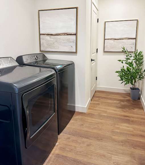 A black oven sits next to a black dishwasher in a kitchen.