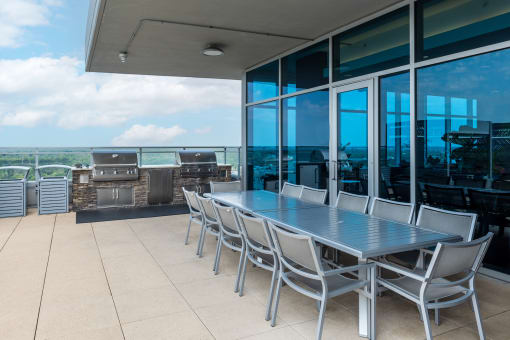 a dining area with a table and chairs on a balcony at Two Twelve Clayton, Clayton, 63105