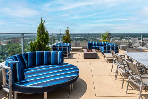 the rooftop terrace at the envoy hotel with blue and white chairs and tables at Two Twelve Clayton, Missouri, 63105