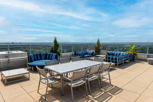 a terrace with a table and chairs on a roof at Two Twelve Clayton, Missouri, 63105